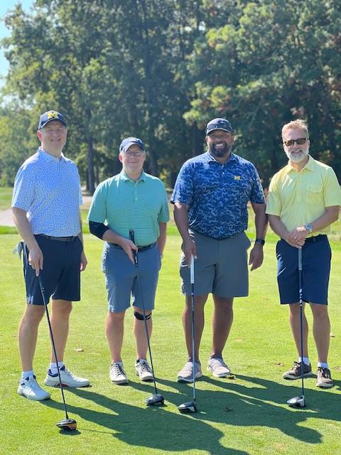 Four alums at the golf tournament.